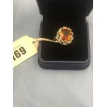 A 9ct white gold dress ring set with orange gem stone size O