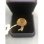 A 9ct yellow gold and ruby dome ring size O