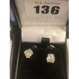 A pair of 18ct gold and diamond stud earrings, total 2.