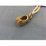 An 18ct gold and diamond shoe pendant