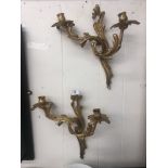 A pair of gilt two branch wall sconces