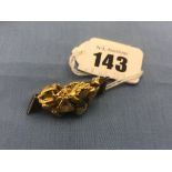 A fine gold nugget set on a brooch with an uncut diamond,