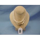 A pearl necklace with 9ct gold clasp set with pearls and rubies