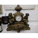 A mantle clock with cherubs