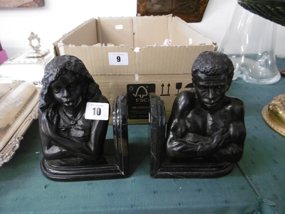 A pair of bronze figural bookends