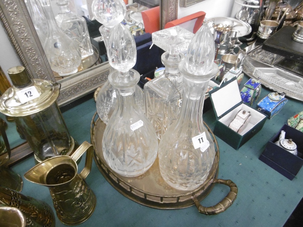 Four cut glass decanters on silver plated tray
