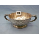 A hallmarked silver twin handle porringer