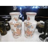 A pair of white and orange oriental vases