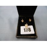 Pair of yellow metal and diamond earrings and matching pendant
