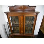 A mahogany art nouveau two door inlaid china cabinet