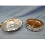 A hallmarked silver wine coaster and a white metal porringer