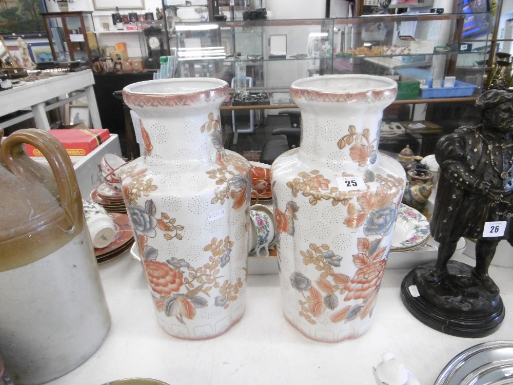 A pair of white and orange oriental vases