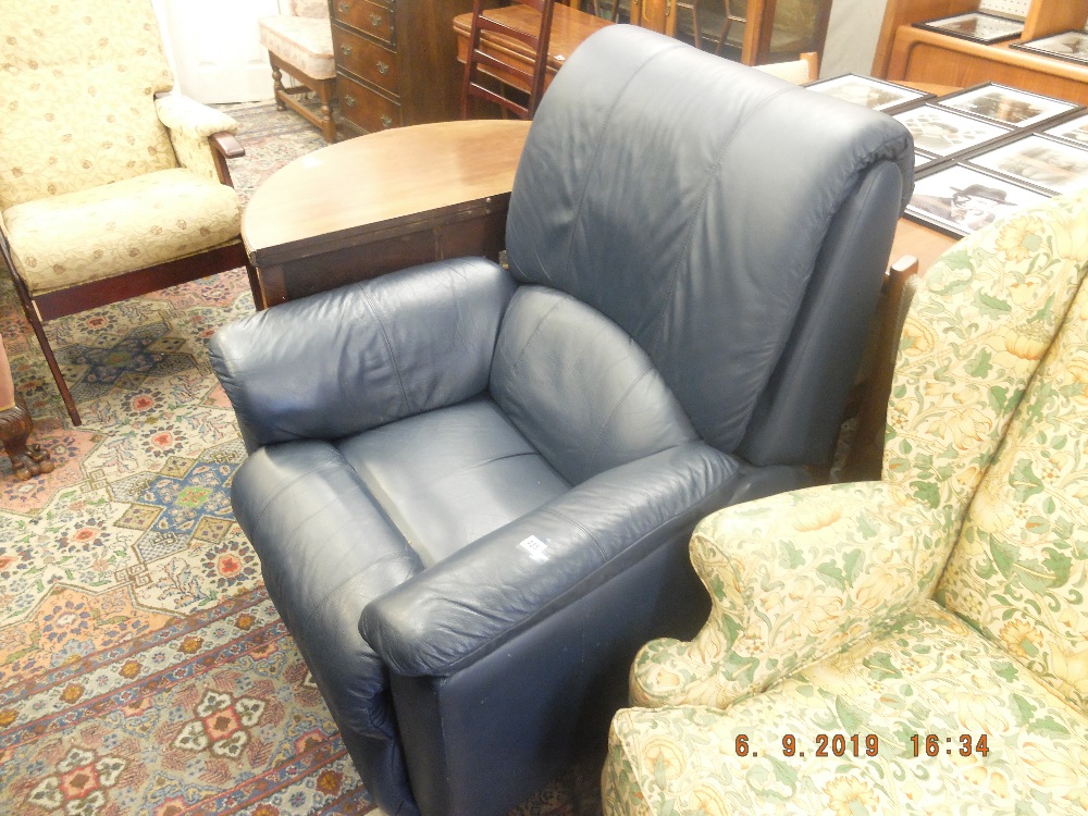 A blue leather reclining arm chair