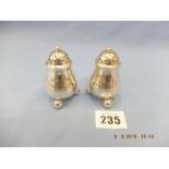 A pair of Victorian silver salt and cayenne pepper pots