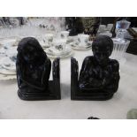 A pair of bronze figural bookends