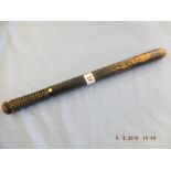 A Victorian turned wood truncheon painted with lion passant guardant over crown over "VR" over "I"