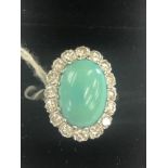 A large turquoise and diamond cluster ring set in white metal (indistinctly marked|) size K