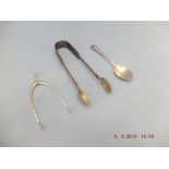 A pair of hallmarked silver wishbone sugar tongs and a pair of hallmarked silver sugar tongs plus a