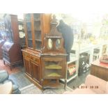 An ebonised corner cabinet