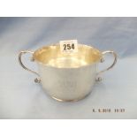 A hallmarked silver twin handle porringer London 1935 J Williams weight 144 grams