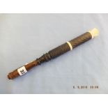 An Edwardian Indian engine turned hardwood truncheon with carved crown length 12.