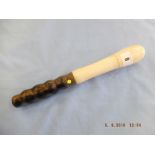 A 19th/20th century turned ivory truncheon with hardwood handle with metal ferrule, 12.
