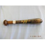 A 19th Century torpedo shaped wooden truncheon painted " Jas.