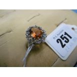 A 9ct white gold dress ring set with orange gem stone size O