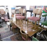 A walnut draw leaf table and six chairs