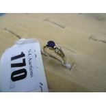 A yellow metal diamond and sapphire three stone ring,