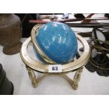 A semi precious stone globe on gmble