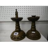 A pair of candlesticks and a cigar lighter