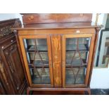 A mahogany art nouveau two door inlaid china cabinet