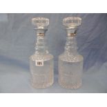 A pair of cut glass decanters with silver collars
