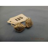 A pair of 14ct gold earrings set with approx.