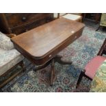 A 19th century fold over mahogany tea table