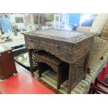 A carved oriental desk and side table