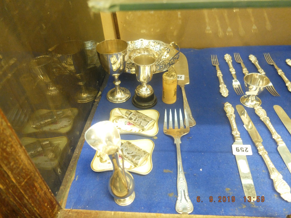 A mixed assortment of small items including silverware and Limoges porcelain