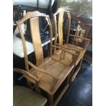 A pair of oriental elbow chairs