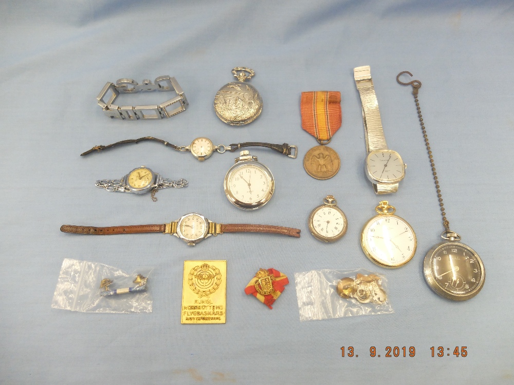 An assortment of watches including a silver fob watch