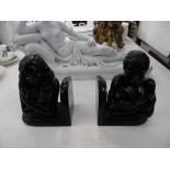 A pair of bronze figural bookends