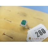 An 18ct gold, emerald and diamond ring, 2.25ct emerald, 16 diamonds 0.75pts approx.