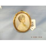 A brass framed miniature painting of a lady signed C Kirk 1910