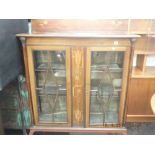 An inlaid mahogany art nouveau two door display cabinet