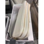 A DKNY white purse, leather, brand new unused, still has labels etc.