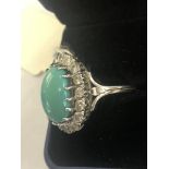 A large turquoise and diamond cluster ring set in white metal (indistinctly marked|) size K