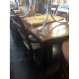 A contemporary extending dining table with two leaves,