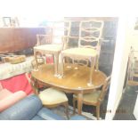 A walnut dining table and six chairs