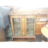 An inlaid mahogany art nouveau two door display cabinet