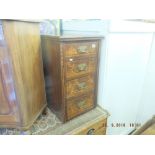 A small rosewood chest of drawers